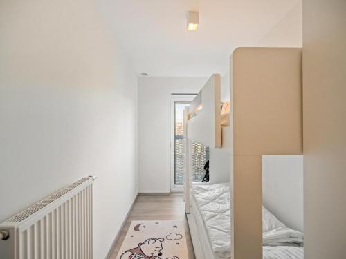 a small white room with a bed and a staircase at B City Complex - 0302 in Blankenberge
