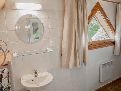 a bathroom with a sink and a mirror and a window at Le Lac Bleu nr 33 in Lacapelle-Marival