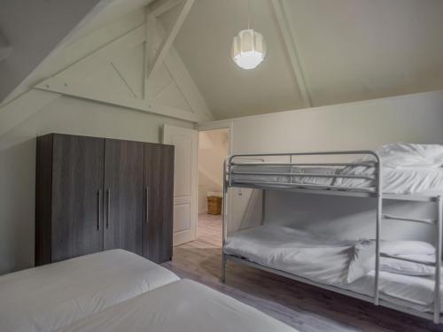 a bedroom with two bunk beds and a cabinet at Lac Bleu nr 19 in Lacapelle-Marival