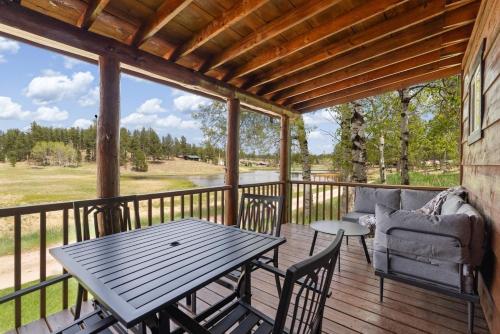 a patio with a table and chairs on a deck at Mountain View Gem BHBungalows #2 in Custer