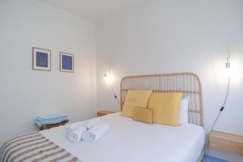 a bedroom with a bed with two towels on it at Feel Nazaré - Ocean Villa in Nazaré