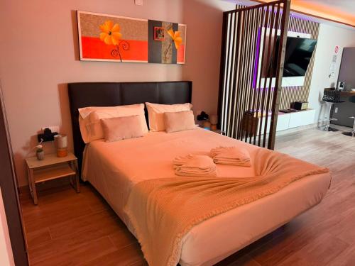 a bedroom with a large bed with orange sheets and pillows at Sweet House 3 in Arrecife