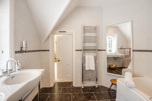 a white bathroom with a sink and a mirror at 6 Bed in Haslemere oc-c34083 in Haslemere
