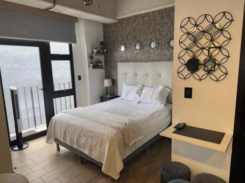 a bedroom with a bed and a large window at EON One Bedroom Apartment 1305 in Estación Pamplona
