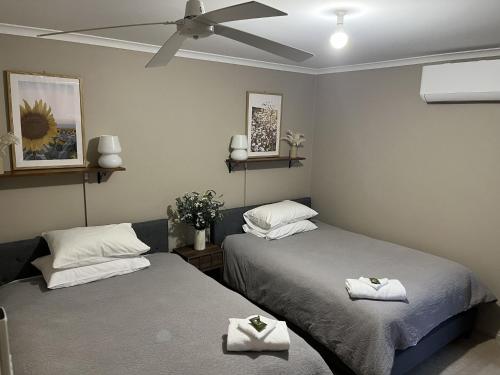 a bedroom with two beds and a ceiling fan at Bella Nicola in Bright