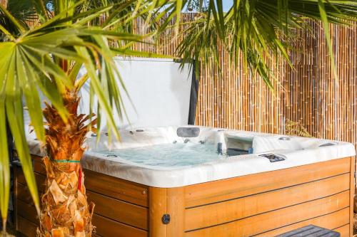 a jacuzzi tub with a palm tree next to it at Citrus Grove in Mesa