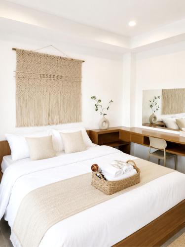 a white bedroom with two beds and a desk at La Vie Résidence in Chiang Mai