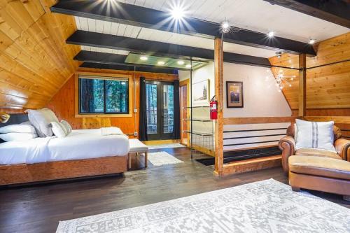 a bedroom with a bed and a couch in a room at Treetop Hideaway, Sleeps 2 in Glacier