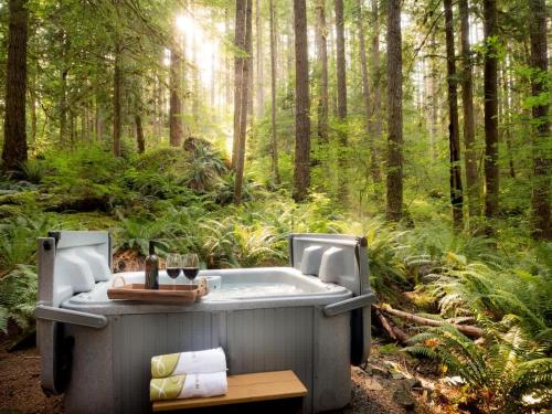a bath tub in the middle of a forest at Treetop Hideaway, Sleeps 2 in Glacier
