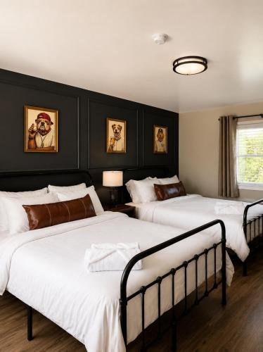 two beds in a bedroom with black walls at KC's Corner Motel in East Springfield