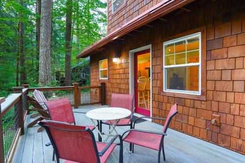 a patio with chairs and a table on a deck at Glacier Pines in Glacier