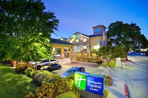 a sign in a parking lot in front of a hotel at Holiday Inn Express Hotel & Suites - Paso Robles by IHG in Paso Robles