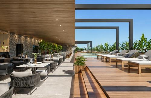 a restaurant with tables and chairs on a deck at Beach Resort in Salinópolis