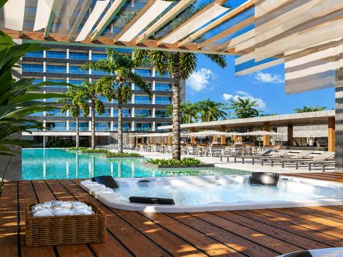 a resort pool with a hot tub on a deck at Beach Resort in Salinópolis