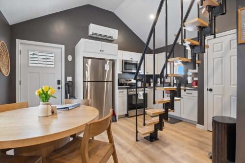 a kitchen and dining room with a table and chairs at Coral Cottage - Tiny Home at Hampton Beach in Hampton