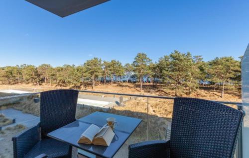 a balcony with a table and chairs with books at Princess in Binz