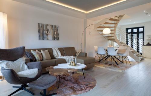 a living room with a couch and a spiral staircase at Diamond in Binz