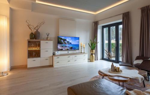 a living room with a television and a couch at Diamond in Binz