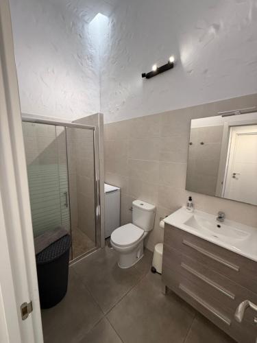 a bathroom with a toilet and a sink and a shower at parking terraza jumbo by stay in gran canaria in Playa del Ingles