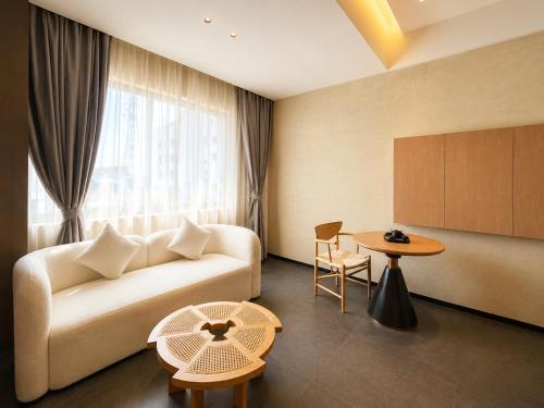 a living room with a couch and a table at Clover Hotel & Spa in Phnom Penh