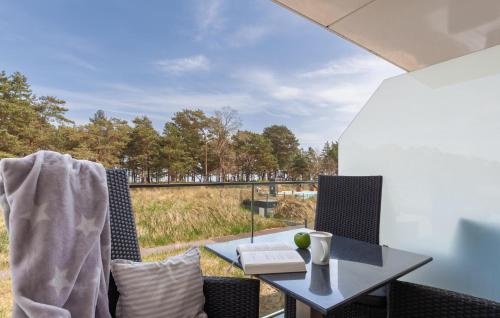 a table and chairs on a patio with a view of a field at Baltic in Binz