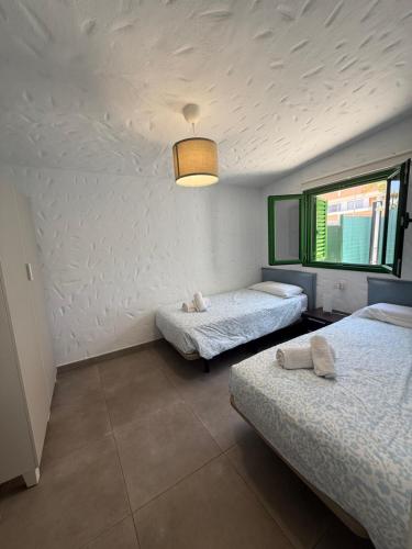 a room with two beds and a window at parking terraza jumbo by stay in gran canaria in Playa del Ingles