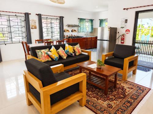 a living room with a couch and two chairs and a table at The Beloved Corner in Nausori
