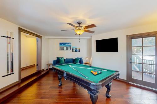a pool table in a living room with a ceiling fan at The Chateau in Lake Arrowhead