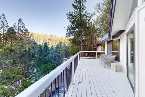 a white deck with a chair on a house at The Snow White in Lake Arrowhead