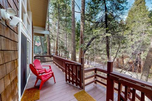 a porch with a red rocking chair on a house at Fernrock Cabin in Twin Peaks