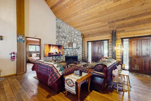 a living room with couches and a stone wall at Sugar Pine Retreat in Twin Peaks