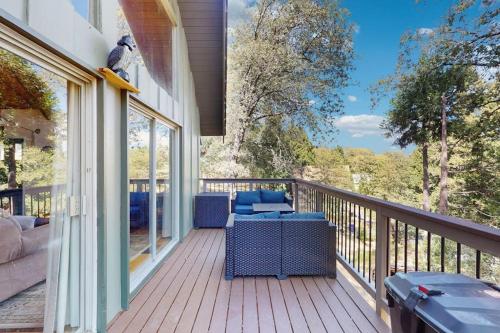 a porch with a couch and chairs on a balcony at Cedar Glen Hideaway in Lake Arrowhead