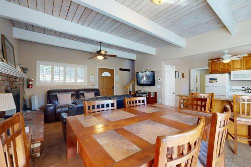 a dining room and living room with a large wooden table at Dancing Bear Chalet in Lake Arrowhead