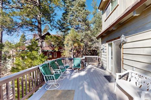 a deck with two chairs on a house at Dancing Bear Chalet in Lake Arrowhead