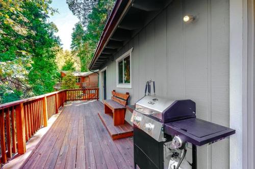 a grill on a porch with a bench on a deck at Sky High Cabin in Crestline