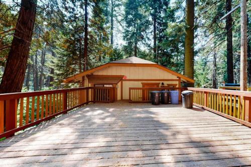 a cabin on a wooden deck in the woods at Morrison Manor in Lake Arrowhead
