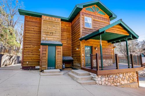 a wooden cabin with a porch and a balcony at Running Springs R-n-R in Running Springs