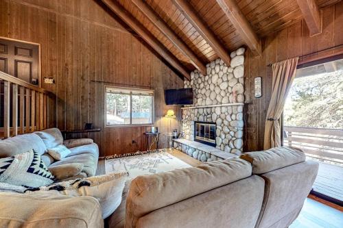a living room with couches and a fireplace at Grey Stone Fire in Running Springs