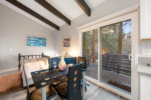 a dining room with a table and a large window at Moonstar Lodge in Lake Arrowhead