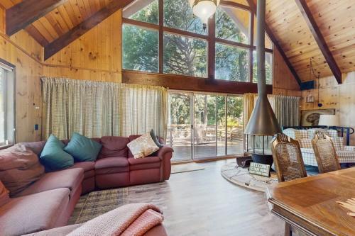 a living room with a couch and a fireplace at Retro Cabin in Lake Arrowhead