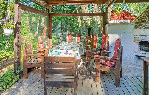 a room with a table and chairs on a porch at Amazing Home In Sävsjö With Kitchen in Sävsjö
