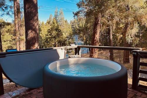 a bath tub sitting on top of a deck at Serene Cabin in Lake Arrowhead