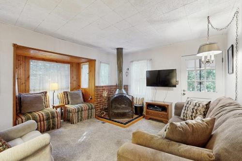 a living room with a couch and a fireplace at The Cottage in Lake Arrowhead