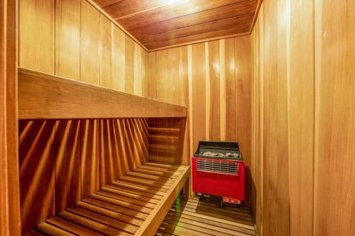 a small sauna with a red heater in it at Timber Top Retreat in Lake Arrowhead