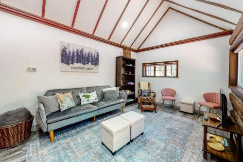 a living room with a couch and a table at Top Town Retreat in Crestline