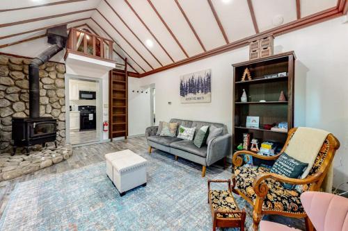 a living room with a couch and a fireplace at Top Town Retreat in Crestline