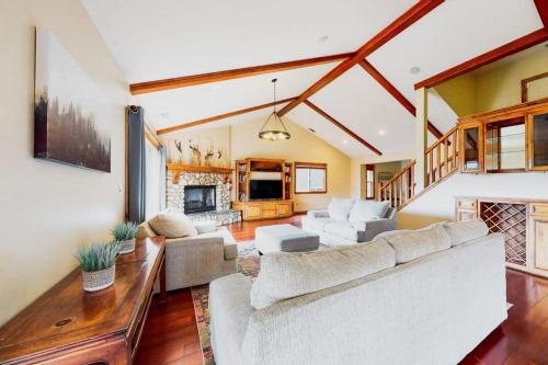 a living room with a white couch and a fireplace at Deer Mountain in Lake Arrowhead