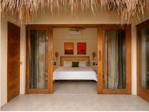 a bedroom with a bed and some glass doors at Villa Xana - Private pool - SOFT OPENING in General Luna