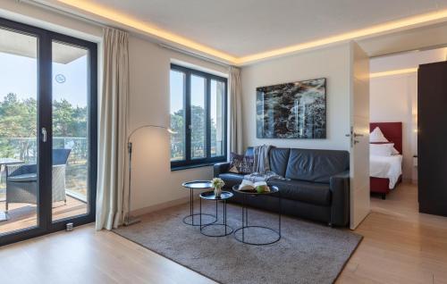 a living room with a couch and a bed at Princess in Binz