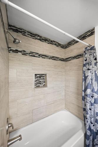 a bathroom with a shower with a shower curtain at Waterfront Gem in Willingboro